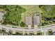 Aerial view of a single-Gathering home with a private backyard next to a pond surrounded by trees at 1846 Moorhen Way, Lutz, FL 33558