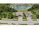 Aerial view of a well-maintained suburban home with a manicured lawn and a pond view at 1846 Moorhen Way, Lutz, FL 33558