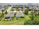 Aerial view of the backyard featuring a screened-in patio and plenty of green space at 1846 Moorhen Way, Lutz, FL 33558