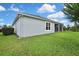 A well-maintained backyard features a view of the home and surrounding trees at 1846 Moorhen Way, Lutz, FL 33558
