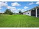 Large backyard with a well-manicured lawn and view of the surrounding community at 1846 Moorhen Way, Lutz, FL 33558