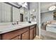 Bathroom vanity with a sink, white countertop, and dark wood cabinets that provides a functional and aesthetically pleasing space at 1846 Moorhen Way, Lutz, FL 33558