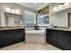 Elegant bathroom with dual vanities, a soaking tub, and stylish wall decor at 1846 Moorhen Way, Lutz, FL 33558