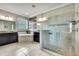 Large bathroom with a soaking tub, a glass-enclosed shower, and dual vanities with granite countertops at 1846 Moorhen Way, Lutz, FL 33558