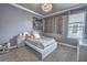 Charming bedroom featuring neutral walls, plush carpet, and a comfortable bed with stylish decor and ample natural light at 1846 Moorhen Way, Lutz, FL 33558