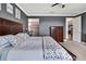 Spacious bedroom with a dark wood bed frame, gray walls, and access to the bathroom and hallway at 1846 Moorhen Way, Lutz, FL 33558