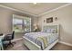 Bedroom with a large window view, modern bed frame and a desk at 1846 Moorhen Way, Lutz, FL 33558