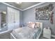 Cozy bedroom with a double closet, and a decorated wall hanging over a bed at 1846 Moorhen Way, Lutz, FL 33558