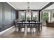 Formal dining room with wainscotting and a modern chandelier at 1846 Moorhen Way, Lutz, FL 33558