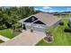 Attractive exterior features a paver driveway, three-car garage, and well-maintained landscaping at 1846 Moorhen Way, Lutz, FL 33558