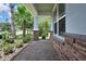 Inviting front porch featuring decorative stone accents and a beautiful tiled walkway at 1846 Moorhen Way, Lutz, FL 33558