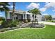 Charming single-story home featuring stone accents, a manicured lawn, and lush landscaping at 1846 Moorhen Way, Lutz, FL 33558