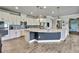 Open kitchen featuring stainless steel appliances, granite countertops, and white cabinets at 1846 Moorhen Way, Lutz, FL 33558