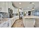 Bright kitchen with stainless steel appliances, an island, granite countertops and white cabinets at 1846 Moorhen Way, Lutz, FL 33558
