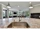 Open kitchen view to the living room with a large kitchen island and modern fixtures at 1846 Moorhen Way, Lutz, FL 33558