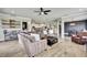 Spacious living room featuring modern design, tile floors, and bright lighting at 1846 Moorhen Way, Lutz, FL 33558