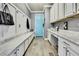 Mudroom with built-in bench, white cabinets, and counter space at 1846 Moorhen Way, Lutz, FL 33558