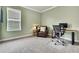 Home office featuring a leather chair, desk, and a window for natural light at 1846 Moorhen Way, Lutz, FL 33558