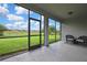 Covered patio with screen and view of the fenced backyard, perfect for enjoying the outdoors at 1846 Moorhen Way, Lutz, FL 33558