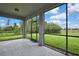 Large screened patio with an open view to the green backyard at 1846 Moorhen Way, Lutz, FL 33558