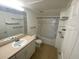 Well-lit bathroom featuring a single sink vanity, tub and shower combination, and tile flooring at 1910 E Palm Ave # 11322, Tampa, FL 33605