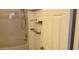 Clean bathroom featuring shower-tub combo and convenient shelving at 1910 E Palm Ave # 11322, Tampa, FL 33605