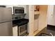 Well-equipped kitchen with stainless steel appliances and a convenient laundry area for easy living at 1910 E Palm Ave # 11322, Tampa, FL 33605