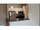 Efficient kitchen with stainless steel appliances, white cabinets, and breakfast bar for modern living at 1910 E Palm Ave # 11322, Tampa, FL 33605