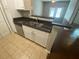 Kitchen with stainless steel dishwasher, granite countertops and white cabinets at 1910 E Palm Ave # 11322, Tampa, FL 33605