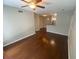 An open living space with hardwood floors flowing into the kitchen area, illuminated by a ceiling fan at 1910 E Palm Ave # 11322, Tampa, FL 33605