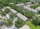 Inviting aerial view of townhomes surrounded by lush green trees in a well-maintained community at 2314 Lake Woodberry Cir, Brandon, FL 33510
