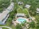 Aerial view of a community pool, cabana, walking paths, and lush landscaping at 2314 Lake Woodberry Cir, Brandon, FL 33510