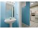 Bathroom featuring a pedestal sink and convenient access to kitchen at 2314 Lake Woodberry Cir, Brandon, FL 33510