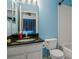 Bathroom features blue walls, granite vanity, and white tiled tub and shower at 2314 Lake Woodberry Cir, Brandon, FL 33510