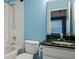 Bathroom featuring blue walls, granite vanity, and white tiled shower at 2314 Lake Woodberry Cir, Brandon, FL 33510