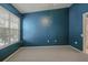 Large bedroom offering neutral carpet, a window with blinds, and blue painted walls at 2314 Lake Woodberry Cir, Brandon, FL 33510