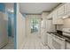 Bright kitchen featuring white appliances, tile floors, and views of the outdoors at 2314 Lake Woodberry Cir, Brandon, FL 33510