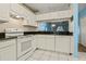 Bright kitchen features white cabinets, granite countertops, and modern appliances at 2314 Lake Woodberry Cir, Brandon, FL 33510