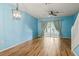 Bright living room with wood floors, ceiling fan, and sliding doors with natural light at 2314 Lake Woodberry Cir, Brandon, FL 33510