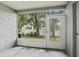 Outdoor patio view with door to backyard, and green trees and plants at 2314 Lake Woodberry Cir, Brandon, FL 33510