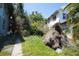 View of the backyard featuring lush greenery and a glimpse of the home at 2355 Trelain S Dr, St Petersburg, FL 33712