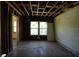 Unfinished bedroom with exposed ceiling beams and natural light, ready for complete customization and remodeling at 2355 Trelain S Dr, St Petersburg, FL 33712