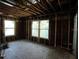 Spacious unfinished bedroom with natural light, featuring exposed framing, and awaiting personal design touches at 2355 Trelain S Dr, St Petersburg, FL 33712