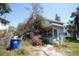 Two-story home exterior view, featuring window views, a front entrance and dead shrubbery at 2355 Trelain S Dr, St Petersburg, FL 33712