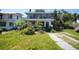 Charming two-story home with a front yard and a partially shaded driveway at 2355 Trelain S Dr, St Petersburg, FL 33712