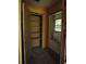 View of a hallway with a closet and open access to a bathroom in need of restoration at 2355 Trelain S Dr, St Petersburg, FL 33712