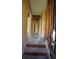 Hallway with steps in need of repair; showing exposed framing, pipework, and requiring modernization at 2355 Trelain S Dr, St Petersburg, FL 33712