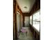 Hallway featuring exposed wood beams, windows, and a small pink table at 2355 Trelain S Dr, St Petersburg, FL 33712