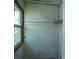 Interior featuring a window, damaged walls, and a glimpse of greenery outside, showcasing disrepair at 2355 Trelain S Dr, St Petersburg, FL 33712