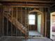 Interior featuring a staircase, exposed framing, and a doorway with natural light streaming through the window at 2355 Trelain S Dr, St Petersburg, FL 33712
